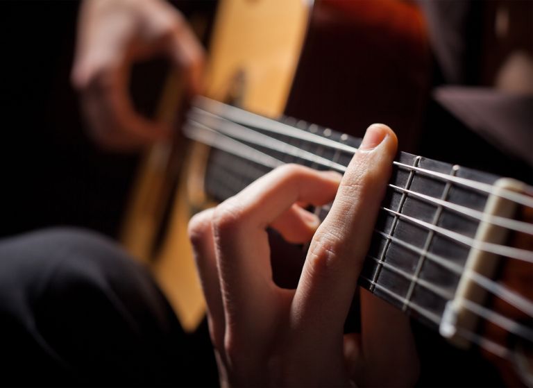 Person playing acoustic guitar 