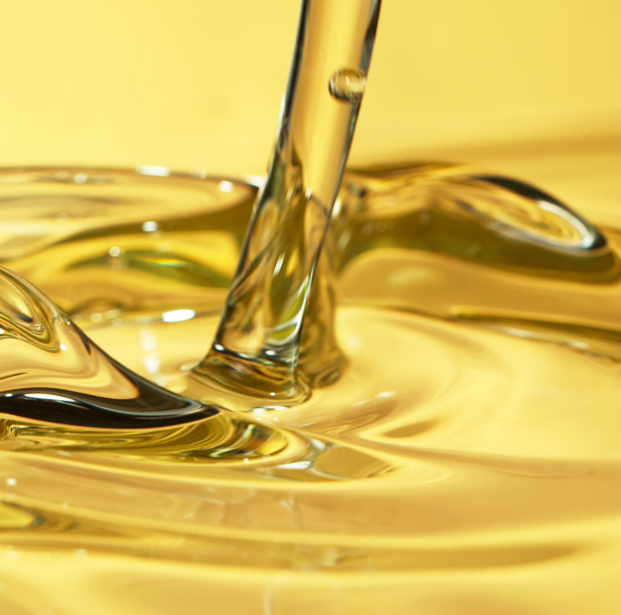 Close-up of oil being poured. 