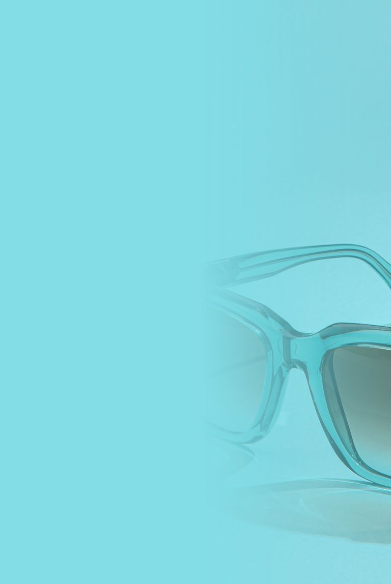 A pair of sunglasses with light blue frames. 