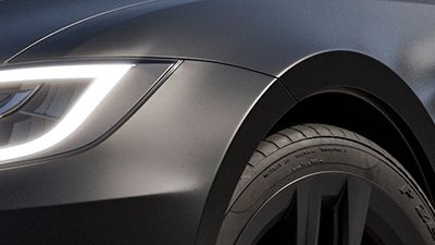 A close-up view of LLumar® Satin Black Protective Wrap Film on front fender