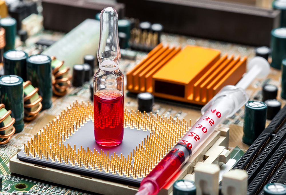 A vial of red liquid sits on an internal electronic component 