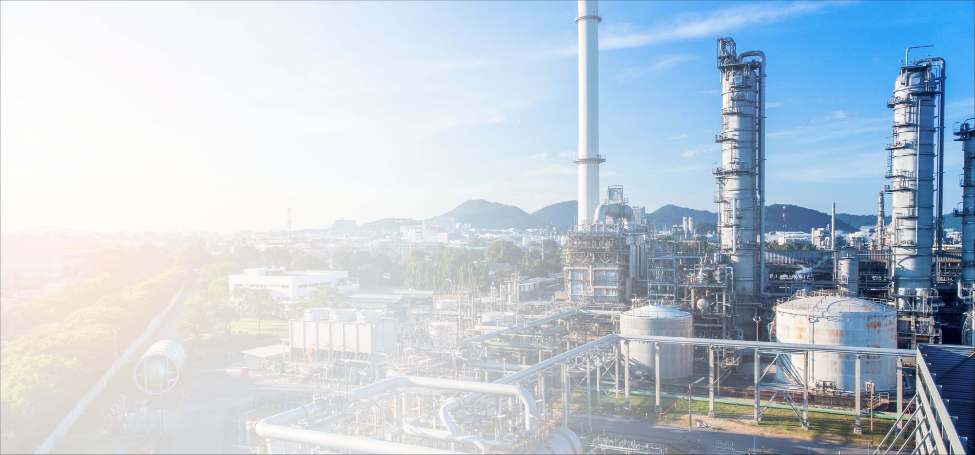 An industrial refinery with a backdrop of a clear blue sky. 
