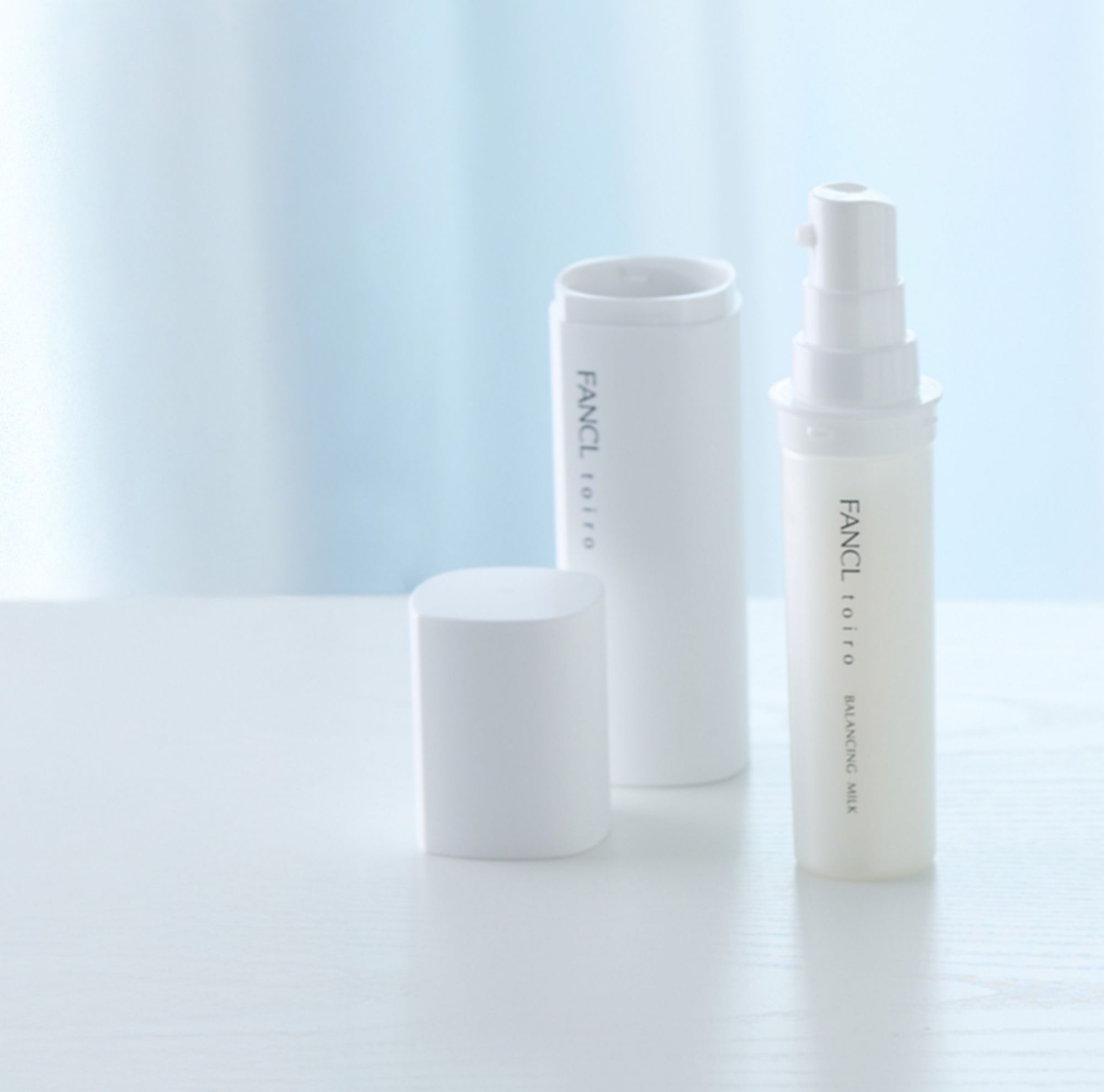 White, reusable FANCL skincare bottle and refillable made with Eastman Tritan copolyester. 