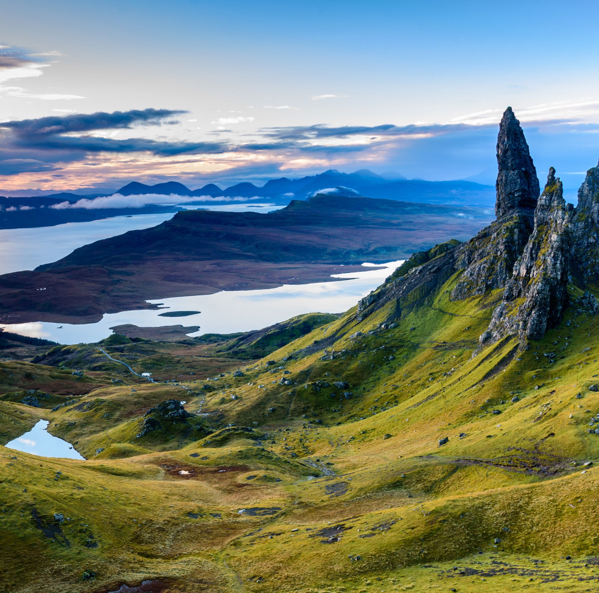 A rocky landscape with lake and mountains. 