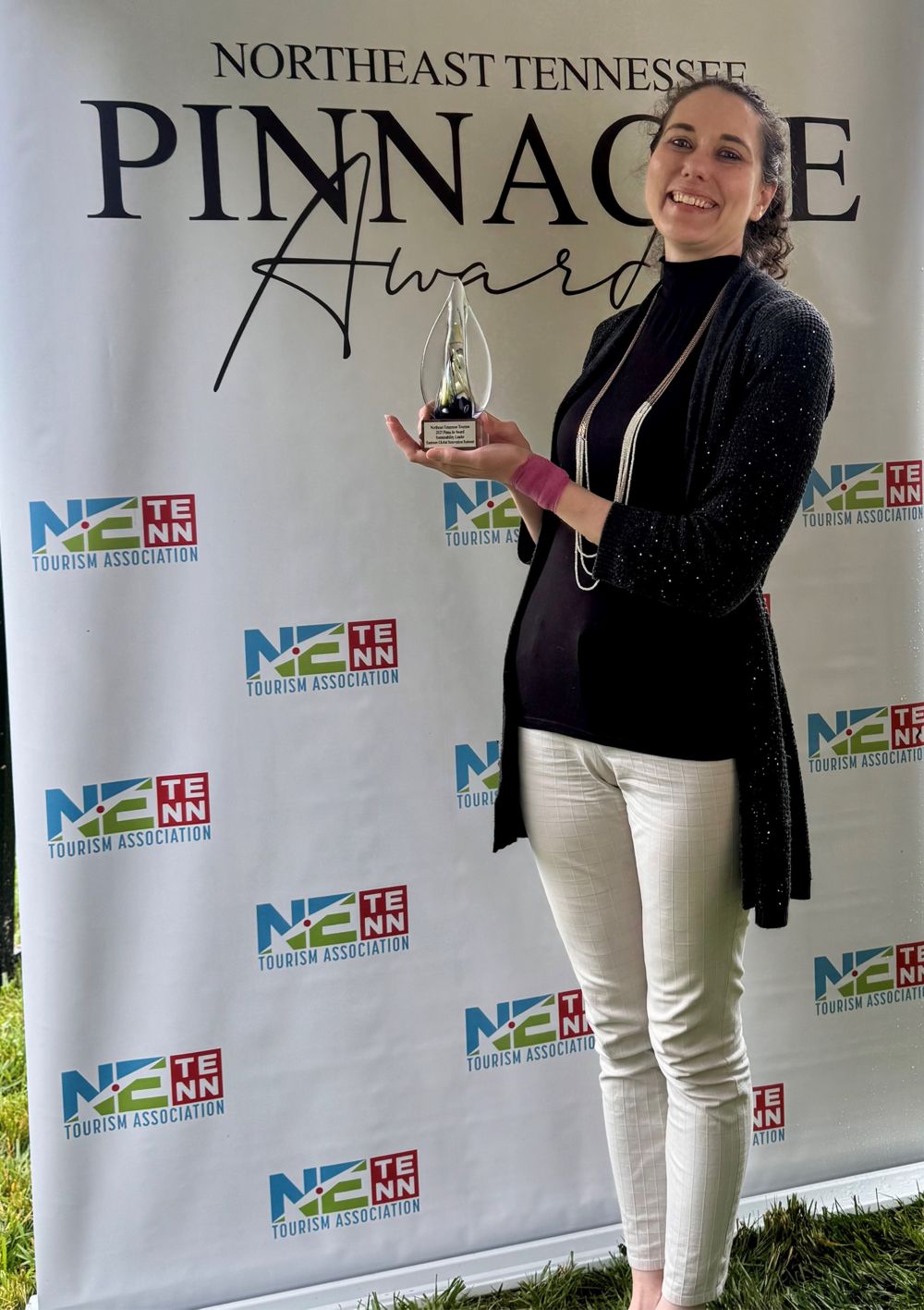 Scientist Katherine Hofmann holds an award. 