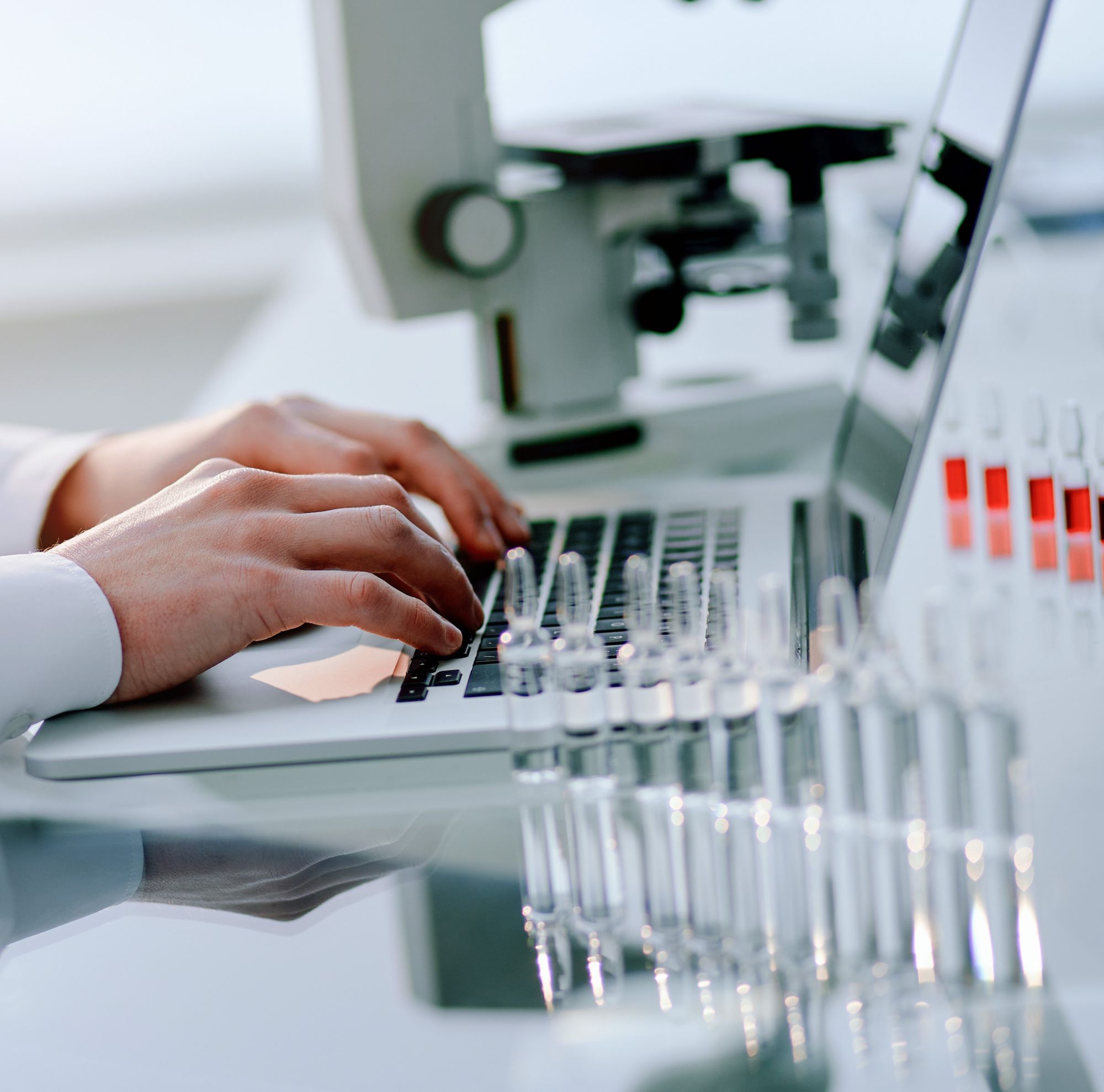 A researcher using their laptop in the science laboratory. 