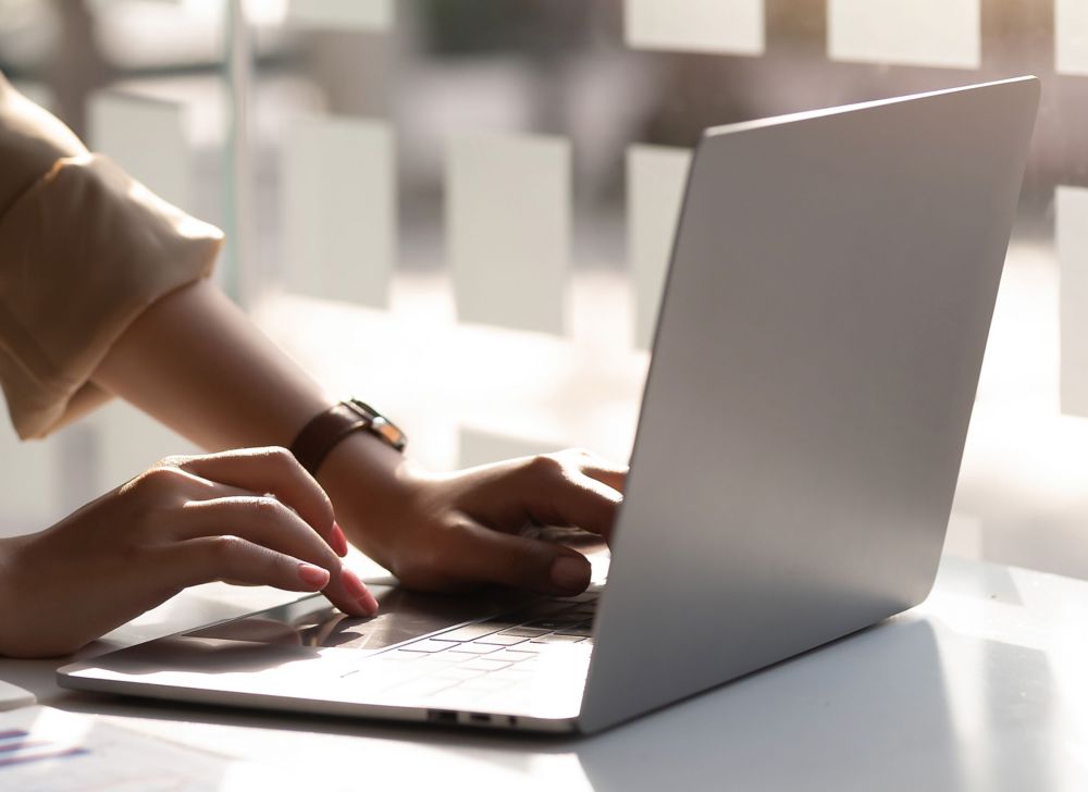 A person uses a laptop. 