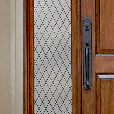 Close up of Gila® Diamond Lattice Sidelight Decorative Window Film on front door