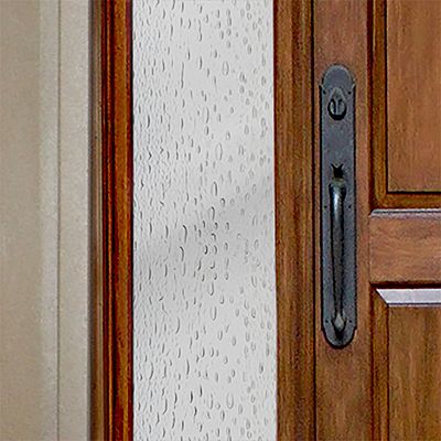 Close up of Gila® Raindrops Sidelight Decorative Window Film on front door