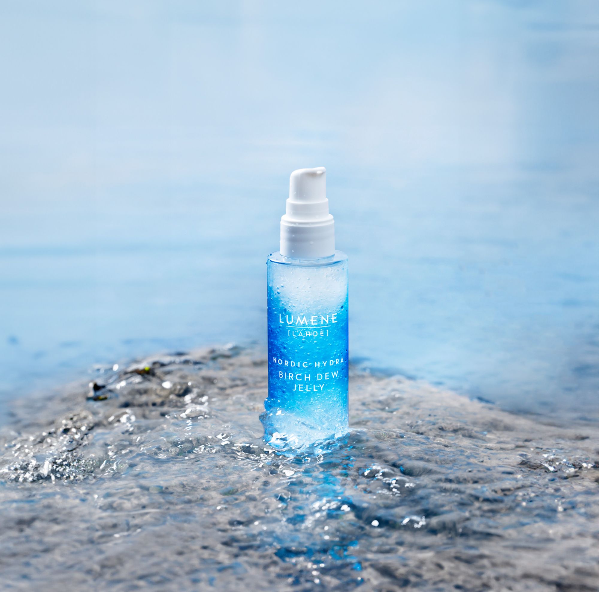 Lumene pump bottle displayed in shallow water 