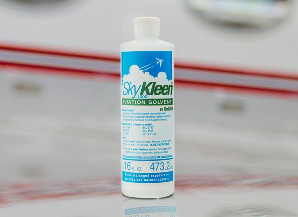 A SkyKleen bottle sits on a surface. 