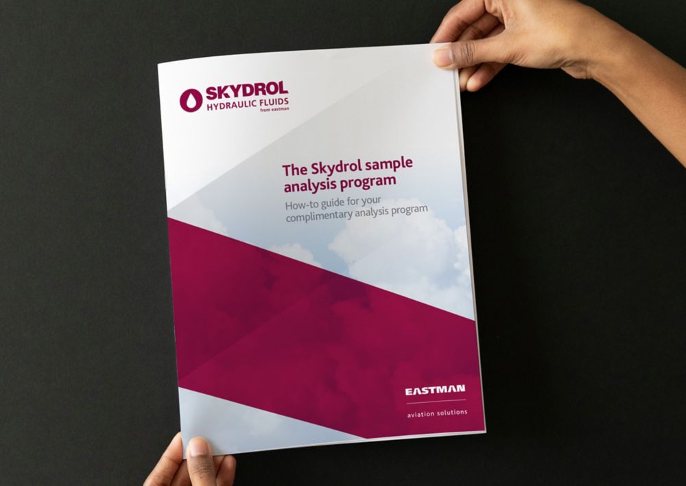 A person holds a brochure about the Skydrol sample analysis program. 