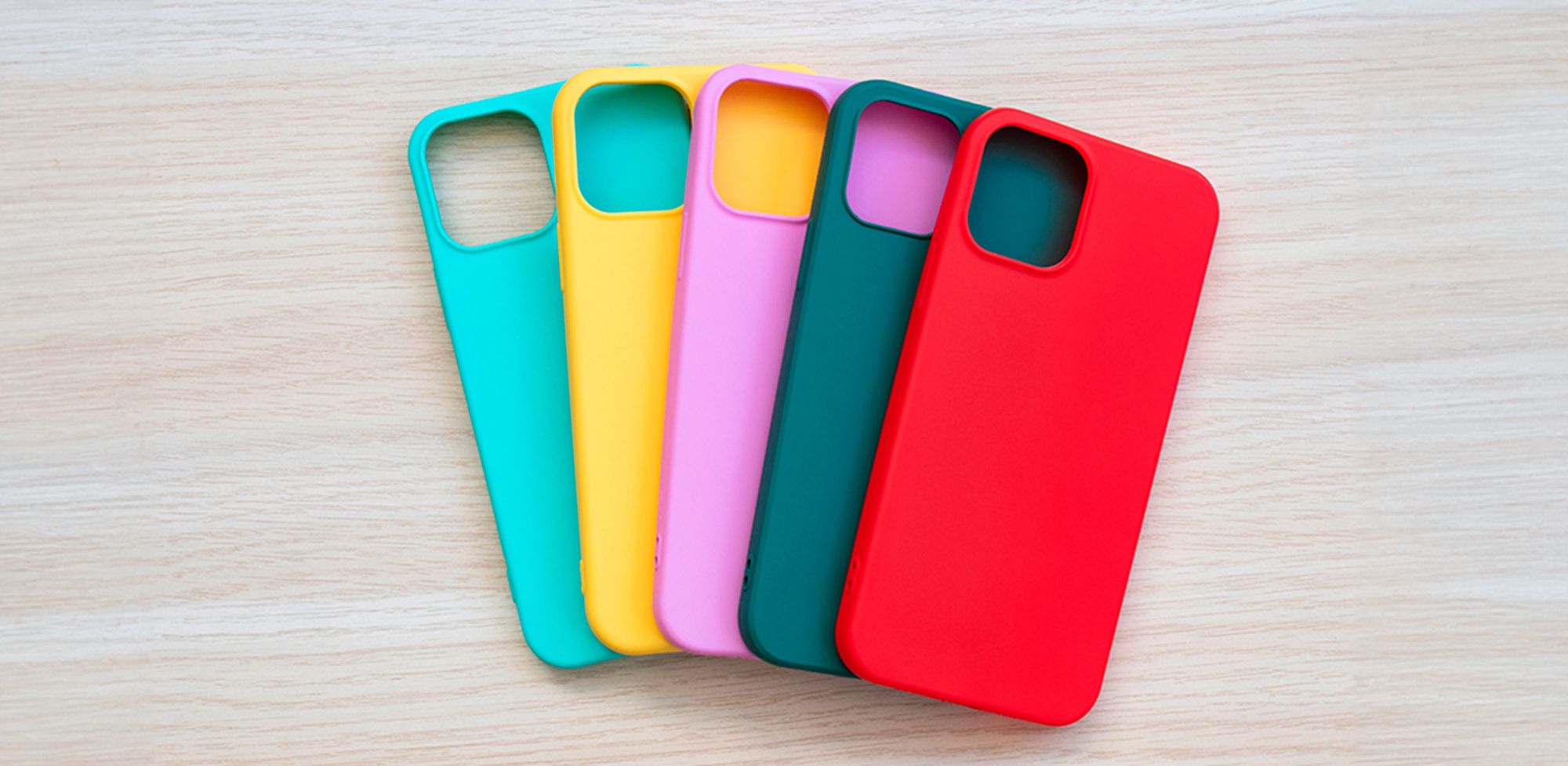 Smartphone covers of assorted colors are spread out. 