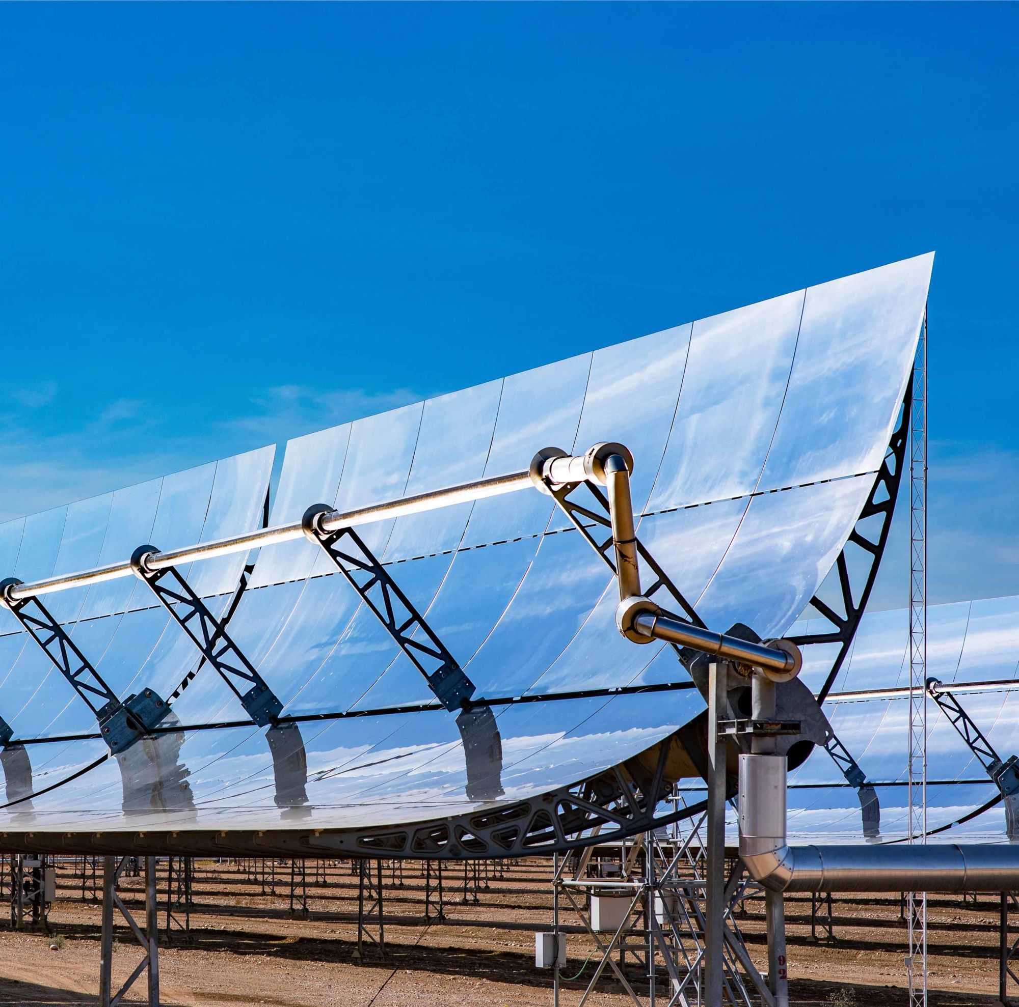 Solar panels sit in a field.  