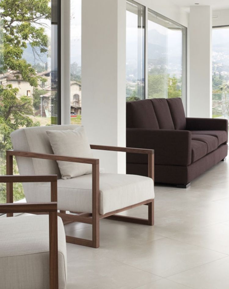 Bright room with floor-to-ceiling windows and modern seating. 