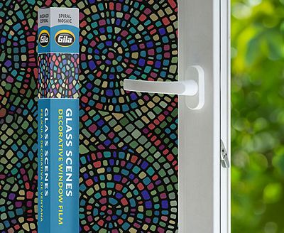 Retail packaging displayed next to a window treated with the Spiral Mosaic decorative film.