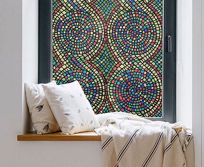 Cozy, private window nook showing the installed Spiral Mosaic film behind throw pillows.