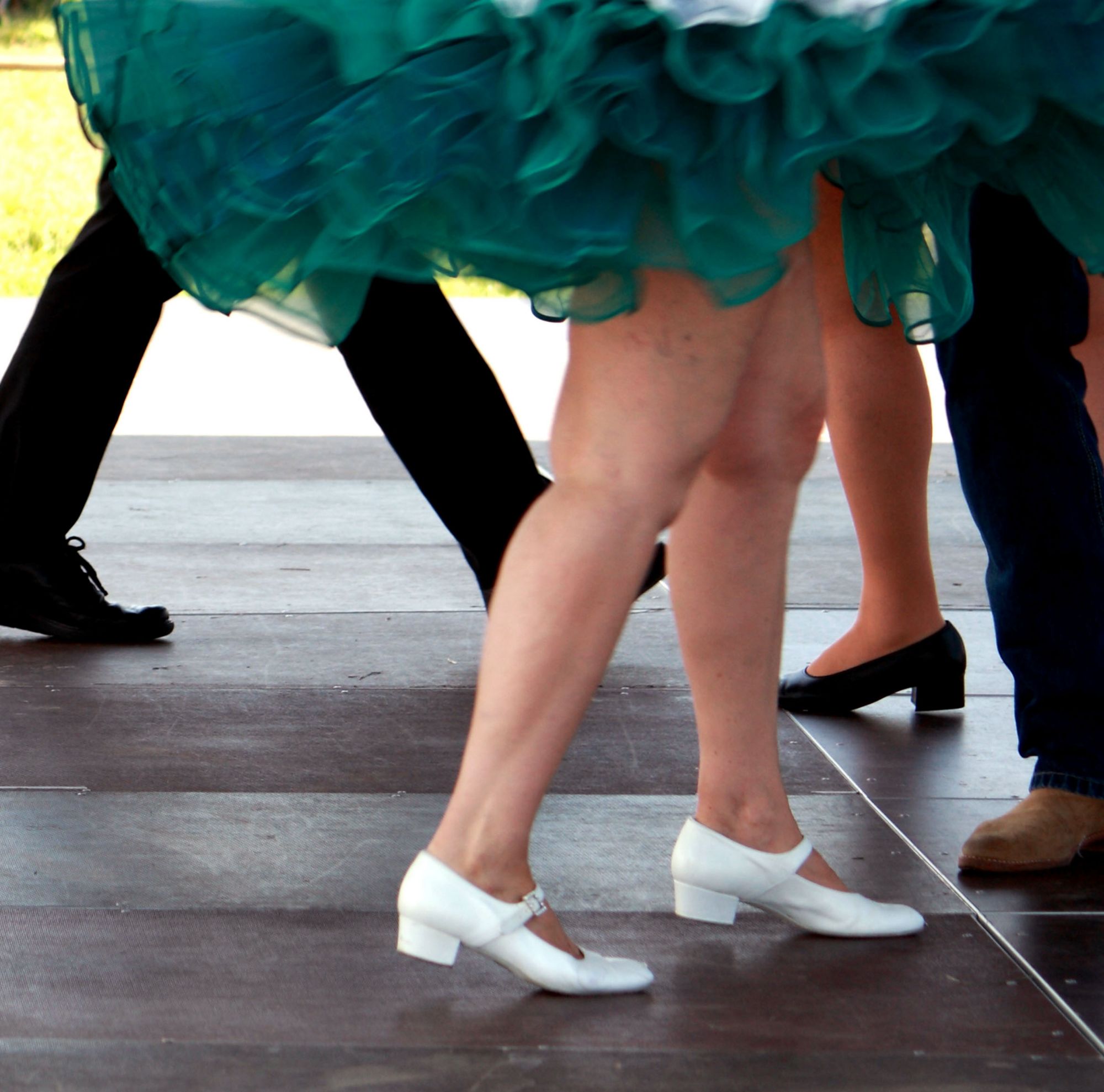 Close up of people dancing square dance. 