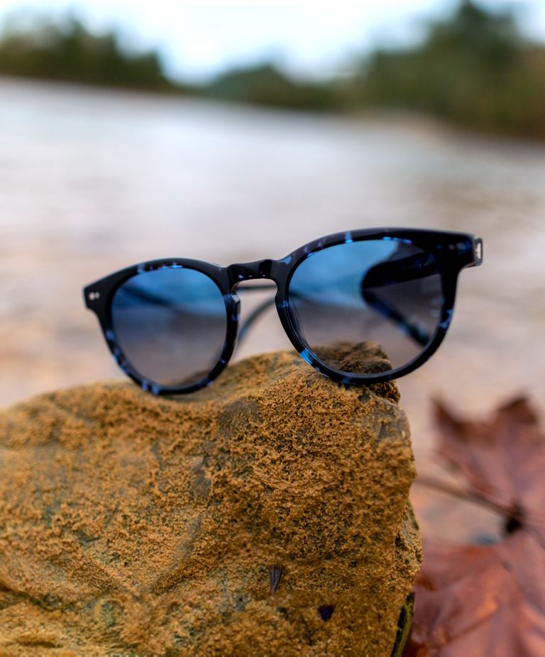 Sunglasses balanced on rock. 