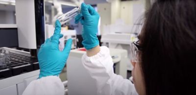 Person in a lab researching for sustainable innovation.