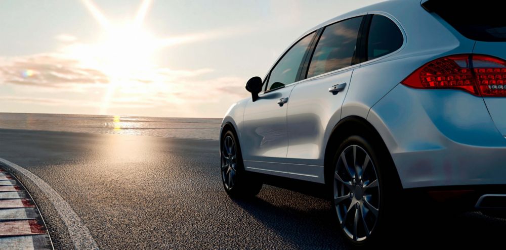 An SUV driving along the coast. 