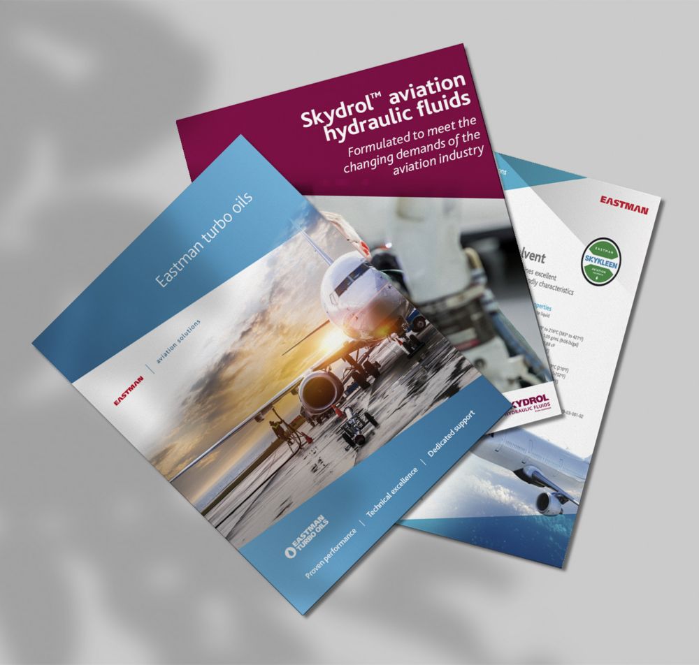Eastman aviation technical brochures are spread out on a surface. 
