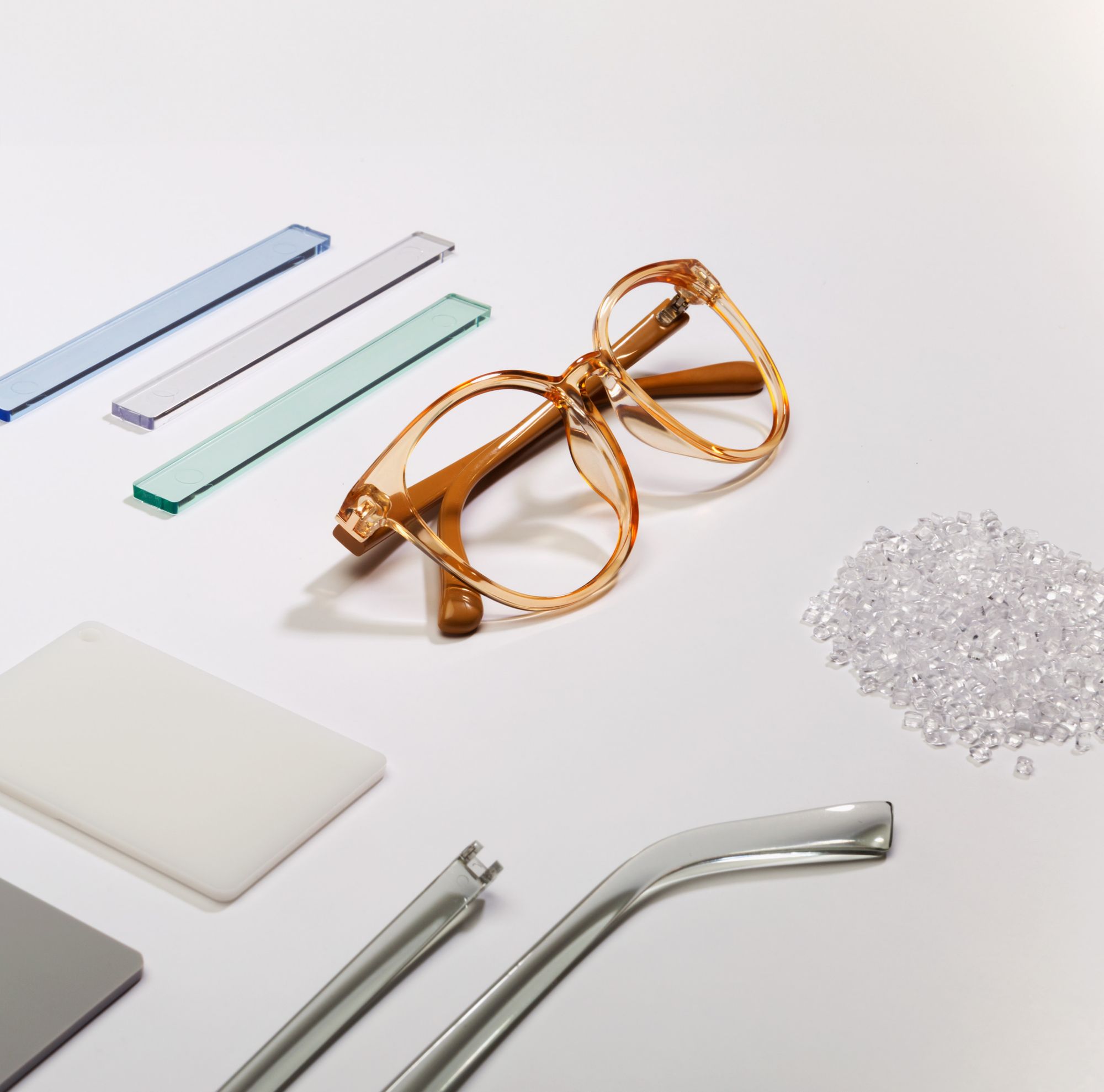 Flat lay of frames and other glasses components made of Tritan. 