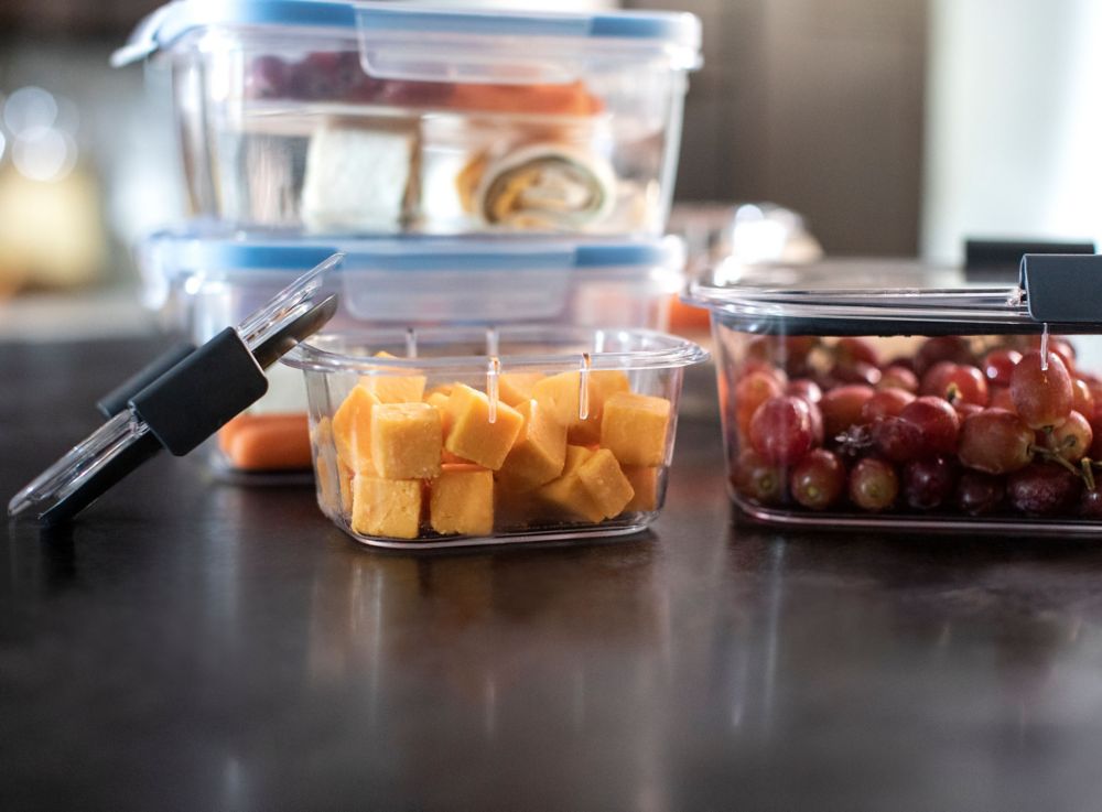 Food containers made from Tritan Renew are filled with grapes, wraps and cheese cubes. 