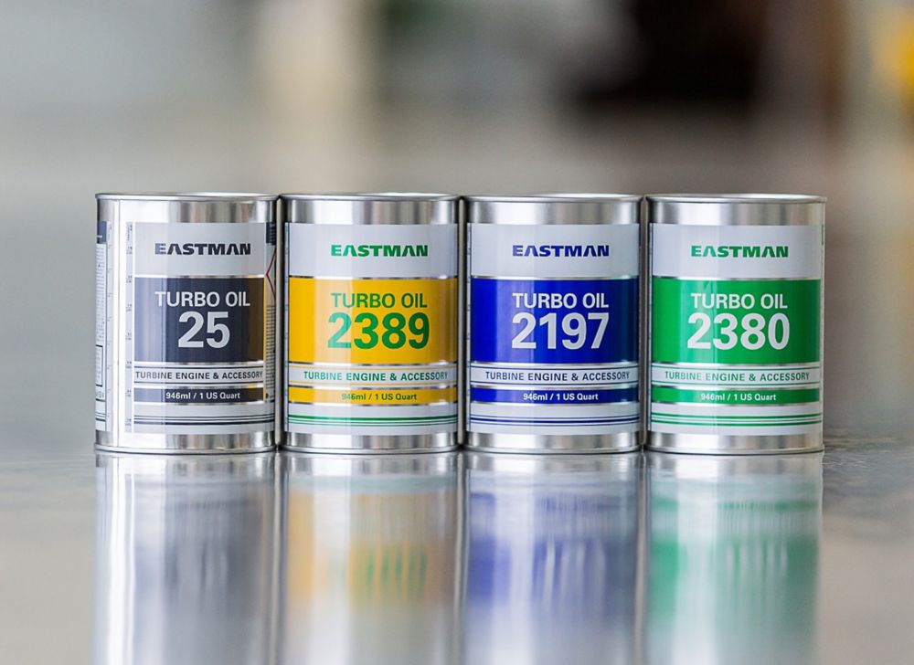 Four cans of turbol oil sit in a row. 