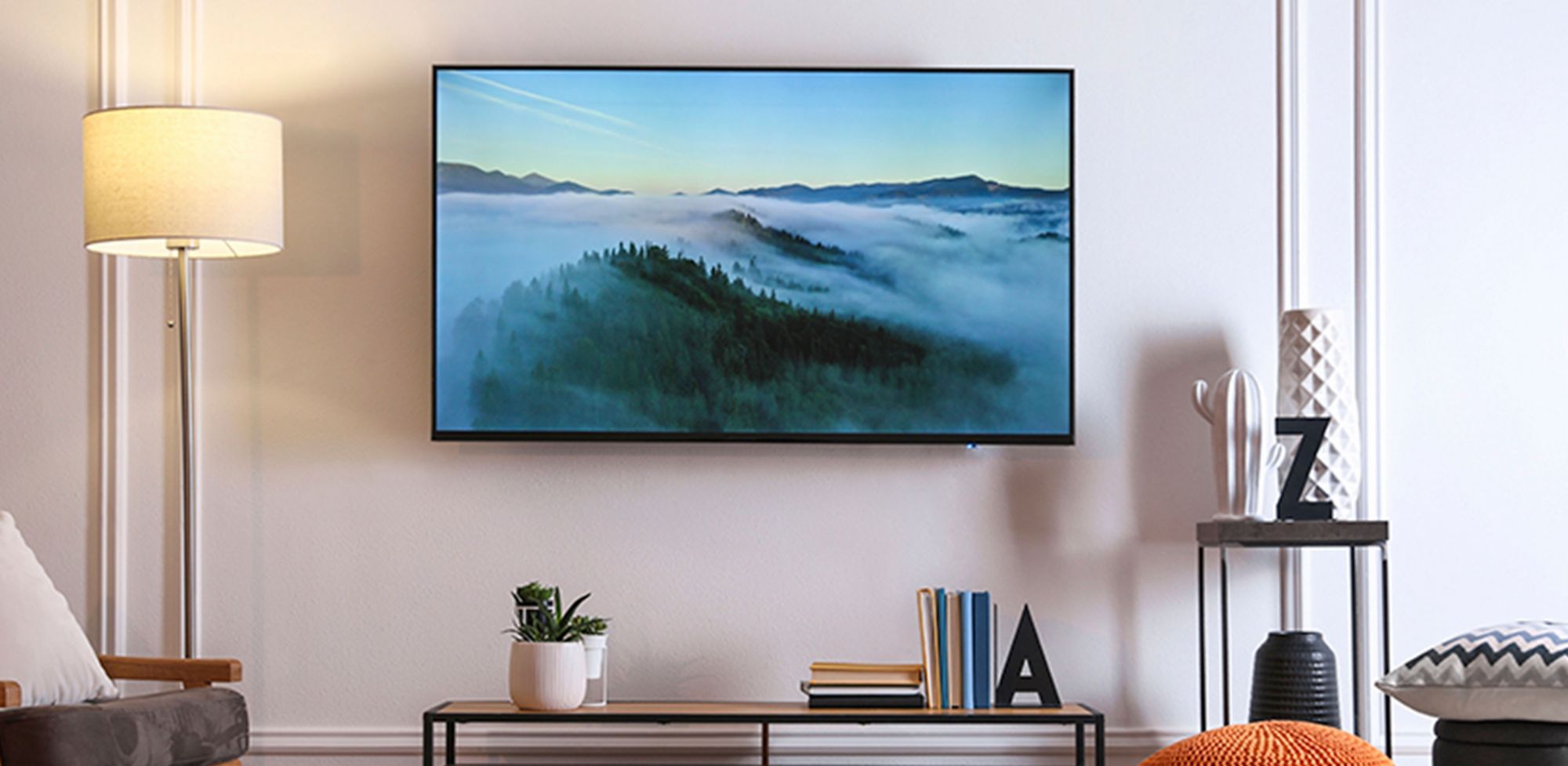 A TV hangs from a wall in a room. 