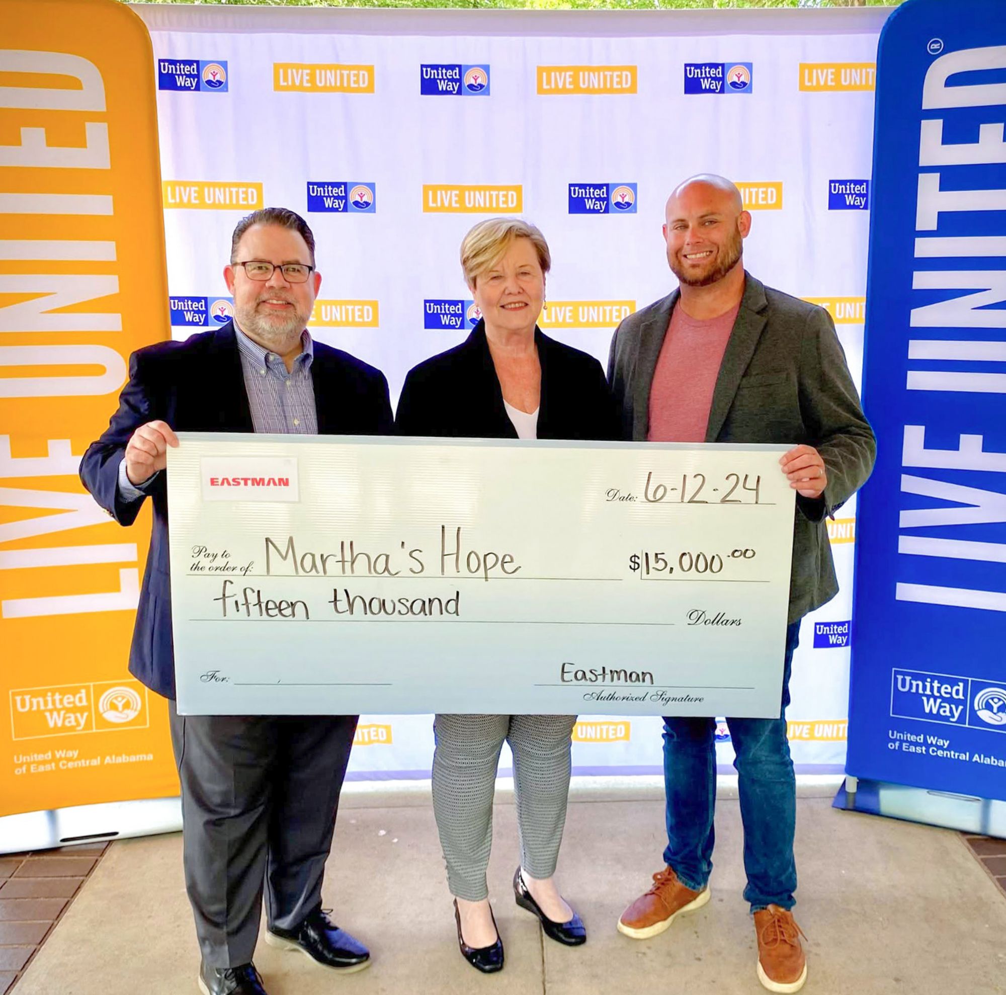 Leaders at Eastman and the United Way present a $15,000 check to Martha’s Hope. 