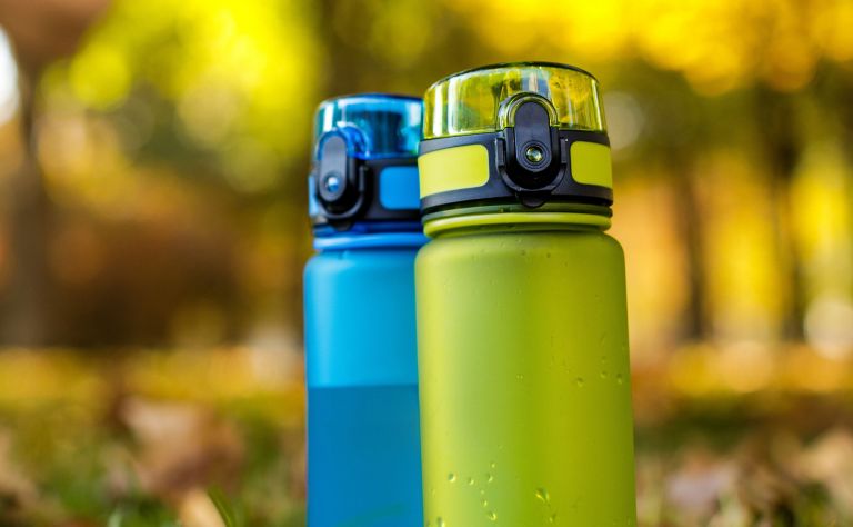 Two reusable water bottles with snap lids.   