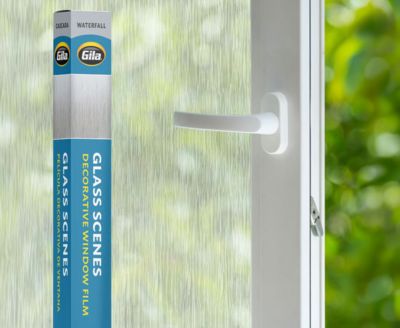 Retail packaging displayed next to a window treated with the Waterfall decorative film.
