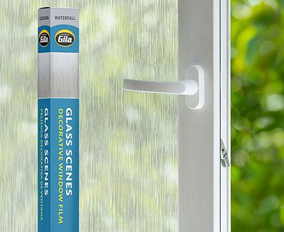 Retail packaging displayed next to a window treated with the Waterfall decorative film.
