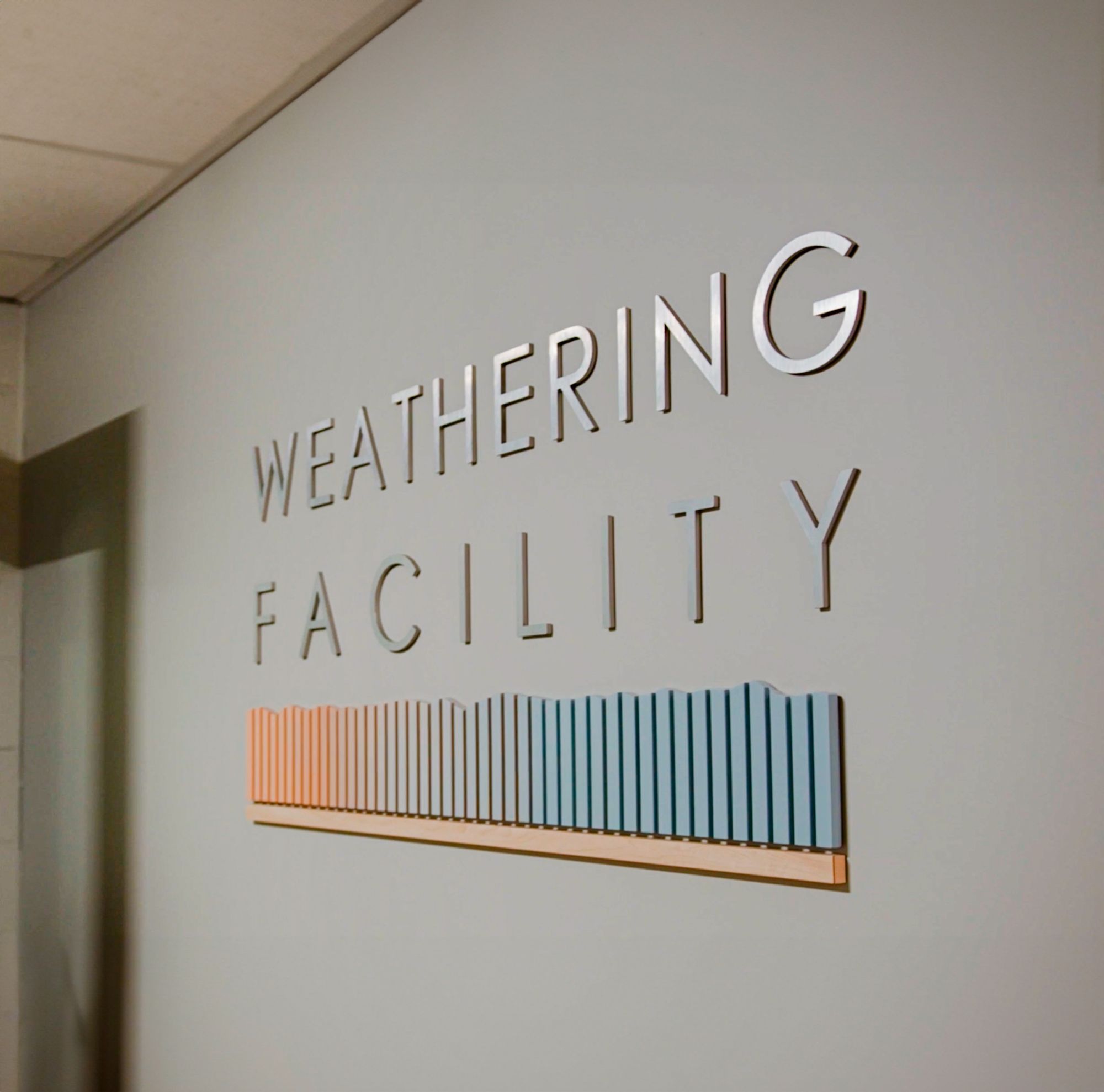 Weathering facility sign. 