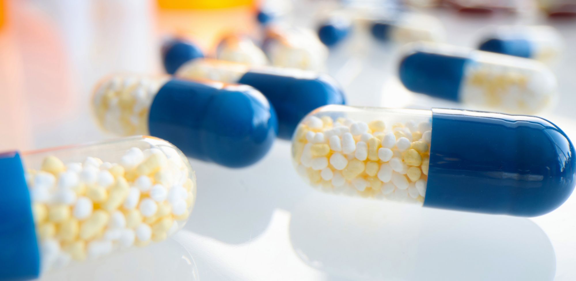 White and blue capsules on a table. 