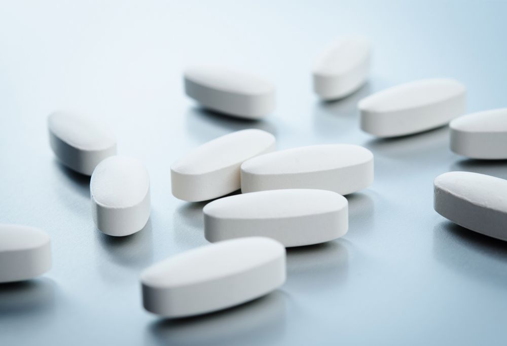 White medical pills on a table. 