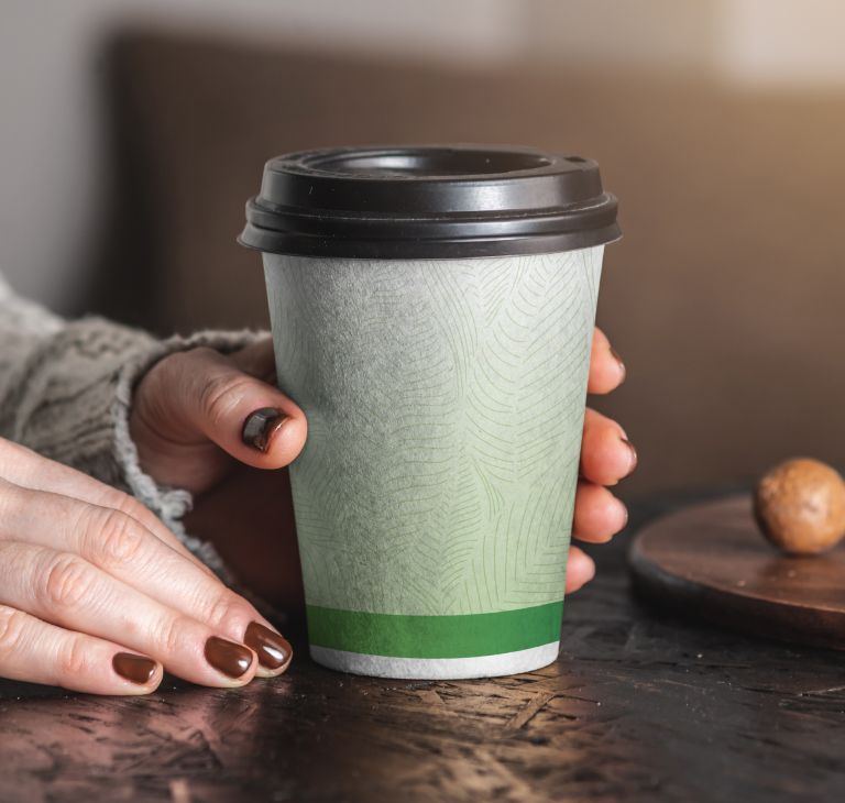 Woman holding paper cup. 