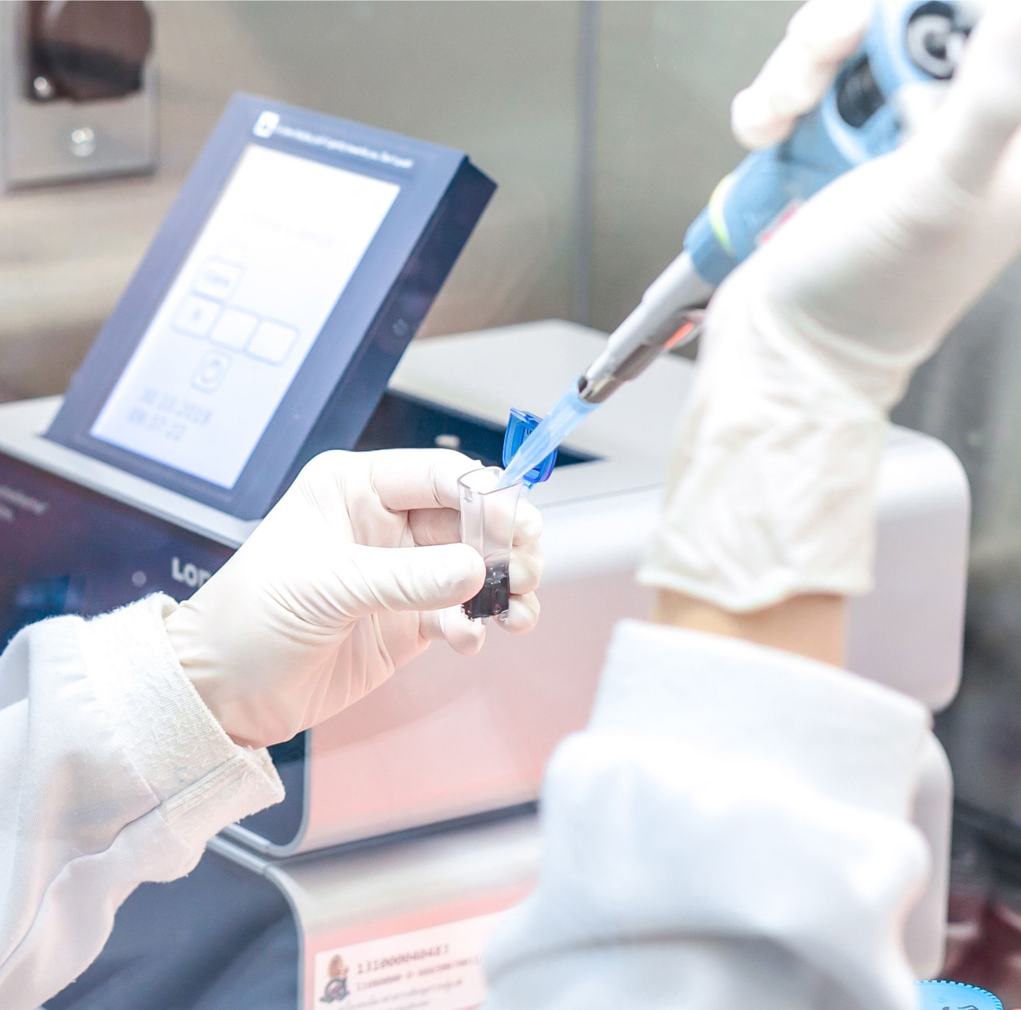 A scientist pipetting. 