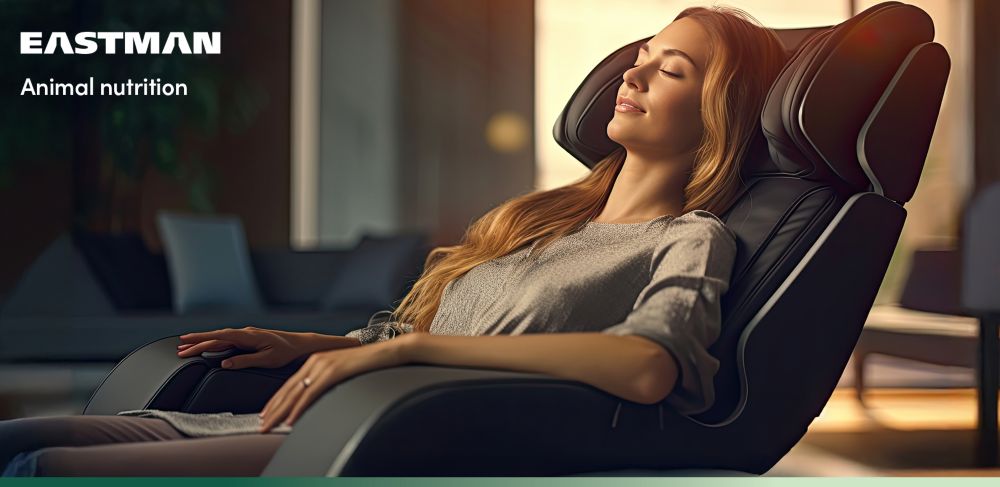 A person in a massage chair relaxes with their eyes closed. 