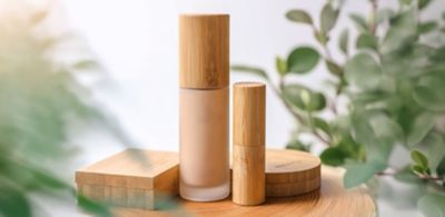 Bamboo‑capped foundation and wooden cosmetic containers 