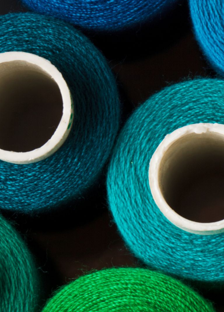 Colorful spools of cellulosic fibers. 